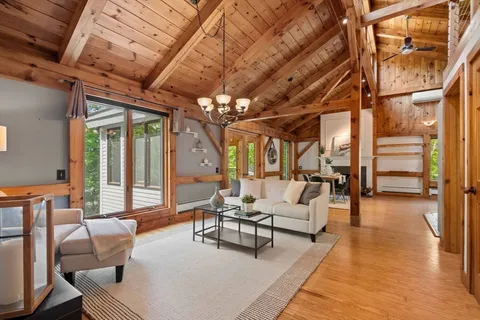 a living room with furniture and a chandelier