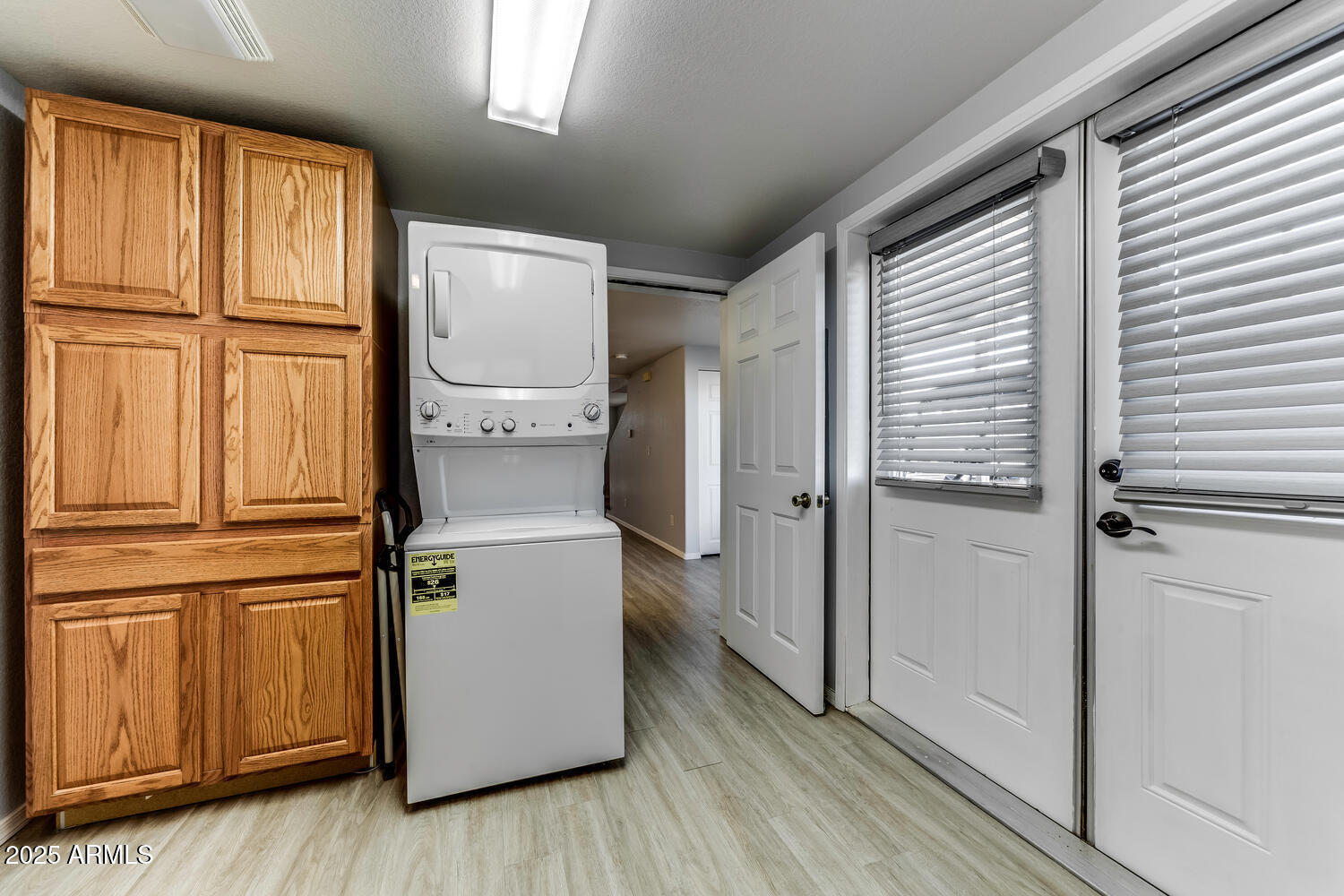 17200 West Bell Road, Unit 1801 Surprise, AZ 85374 - Photo 11 of 40 a view of a refrigerator in kitchen and wooden floor