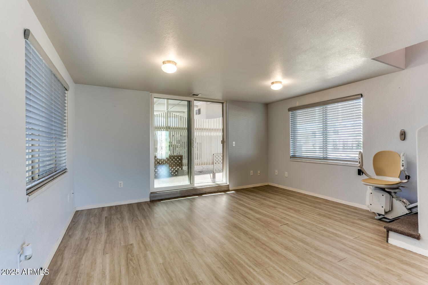 17200 West Bell Road, Unit 1801 Surprise, AZ 85374 - Photo 22 of 40 a view of an empty room with wooden floor and a window