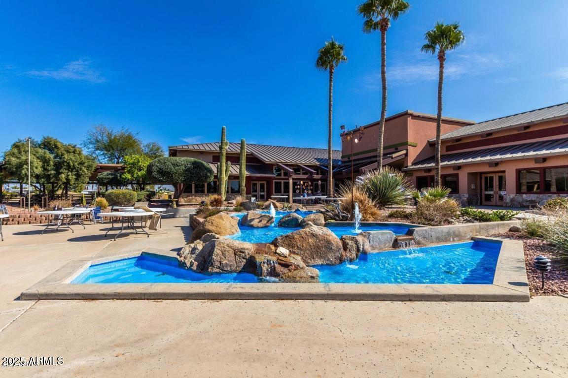 17200 West Bell Road, Unit 1801 Surprise, AZ 85374 - Photo 36 of 40 a view of a swimming pool with chairs