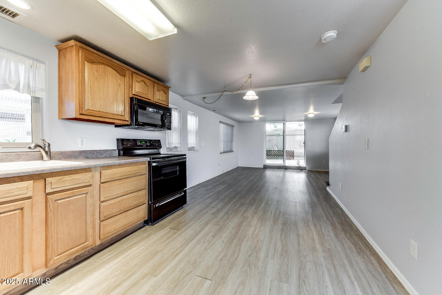17200 West Bell Road, Unit 1801 Surprise, AZ 85374 - Photo 8 of 40 a kitchen with stainless steel appliances a refrigerator sink and cabinets