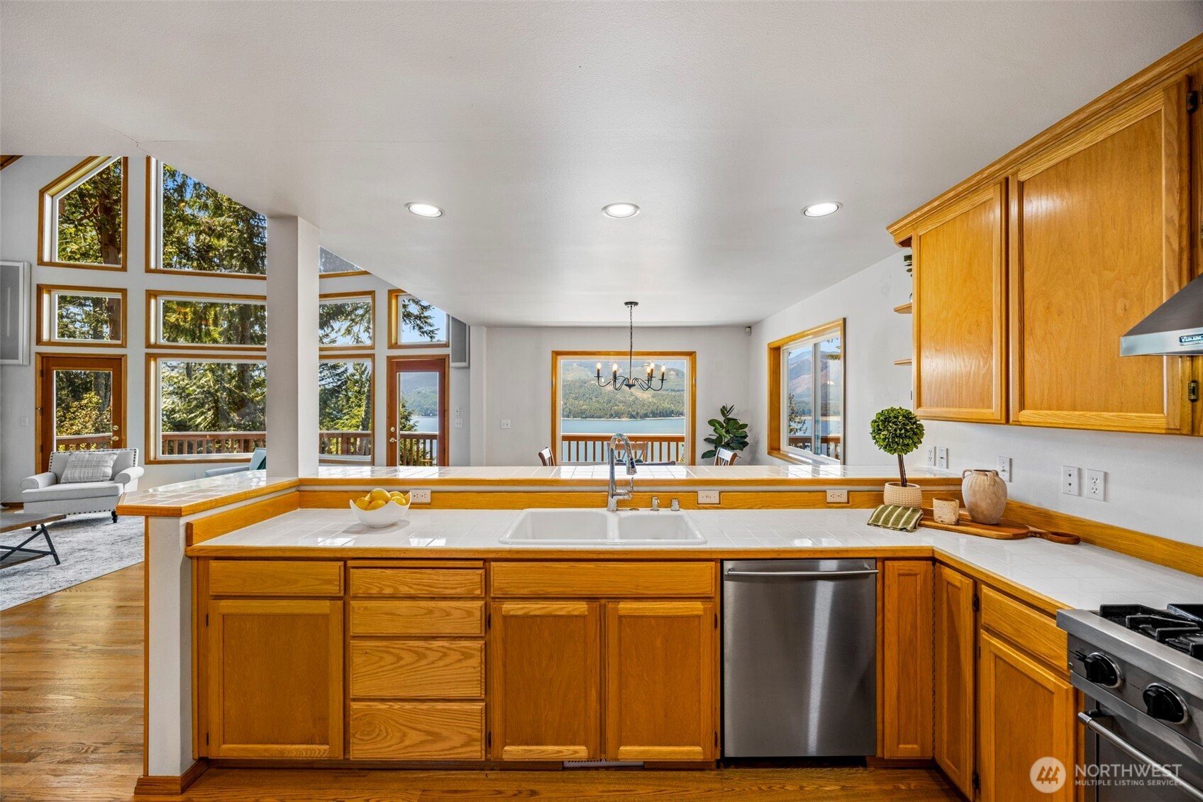 19736 Northwest Stavis Bay Road Seabeck, WA 98380 - Photo 10 of 39 a view of a kitchen with a sink and large window