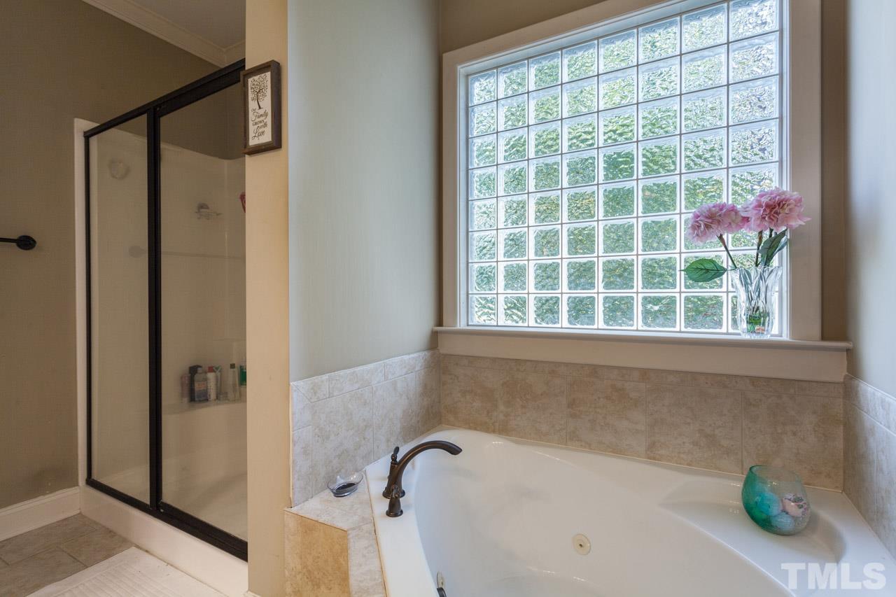 47 High Ridge Court Willow Spring, NC 27592 - Photo 14 of 25 a bath tub sitting next to a window