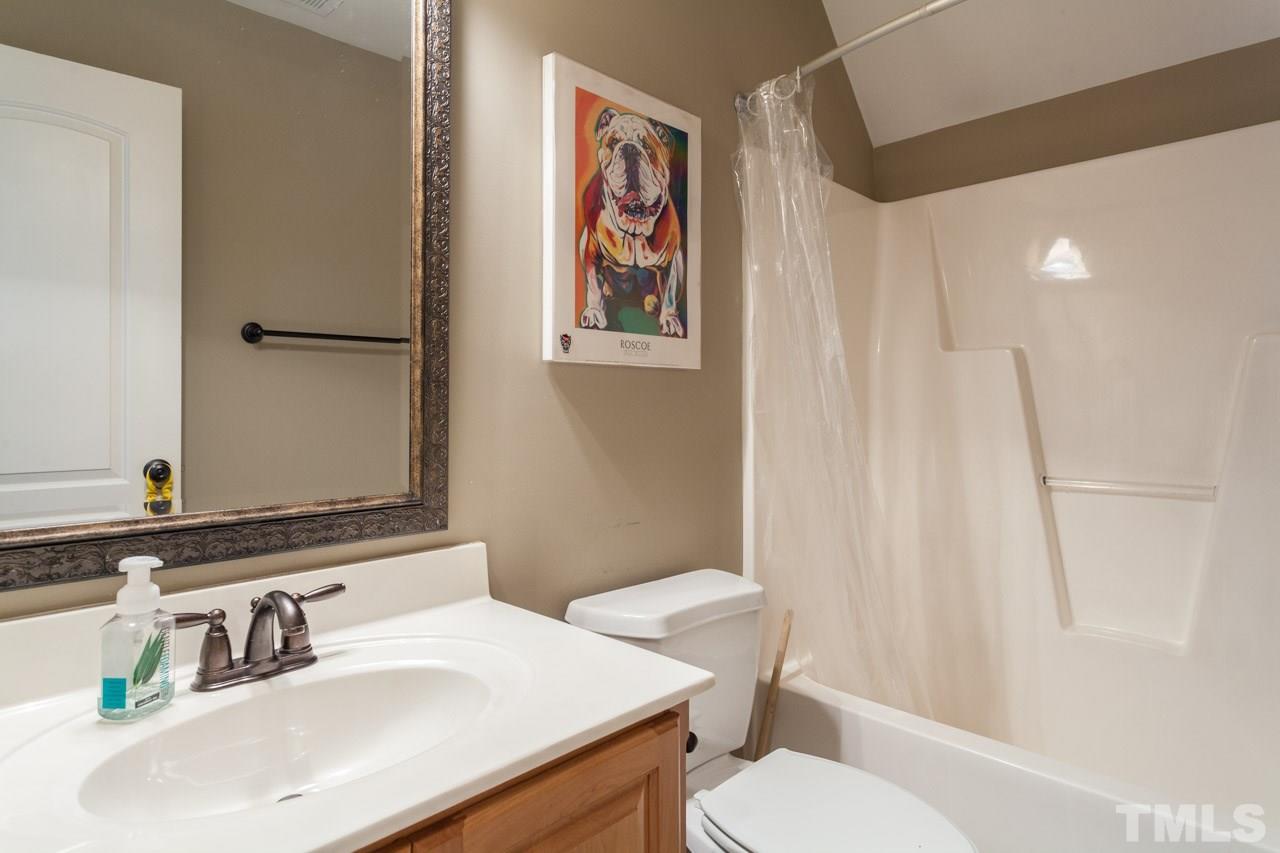 47 High Ridge Court Willow Spring, NC 27592 - Photo 21 of 25 a bathroom with a sink mirror vanity and toilet