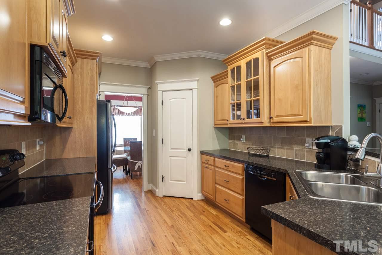 47 High Ridge Court Willow Spring, NC 27592 - Photo 9 of 25 a kitchen with stainless steel appliances granite countertop a sink stove and refrigerator