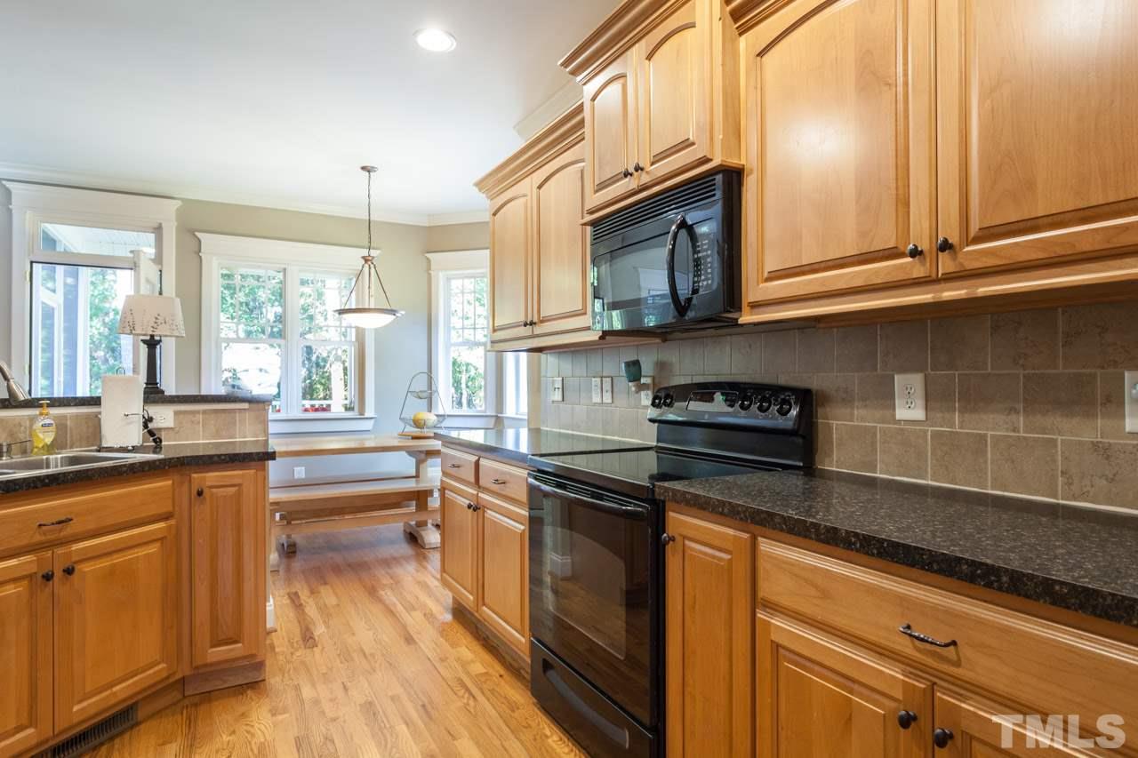 47 High Ridge Court Willow Spring, NC 27592 - Photo 10 of 25 a kitchen with stainless steel appliances granite countertop a sink a stove and cabinets