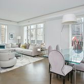 a living room with furniture and floor to ceiling windows
