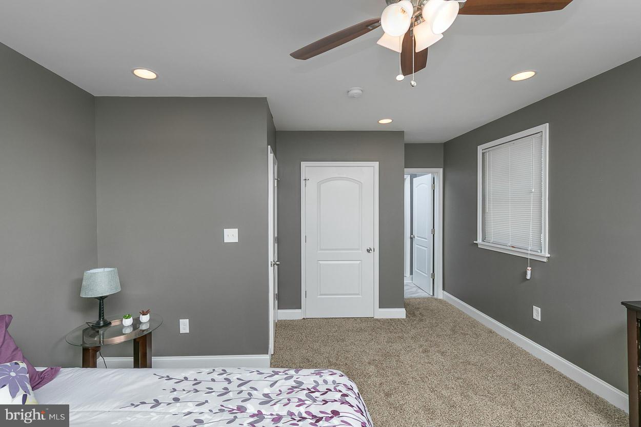 8221 Longpoint Road Baltimore, MD 21222 - Photo 15 of 24 a bedroom with a bed and a chandelier