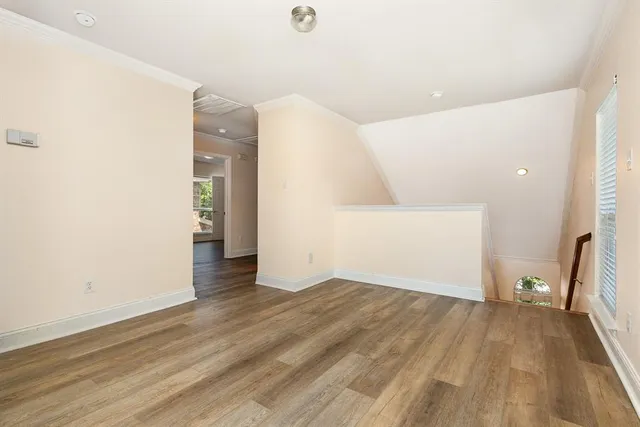 a view of a big room with wooden floor and a bathroom