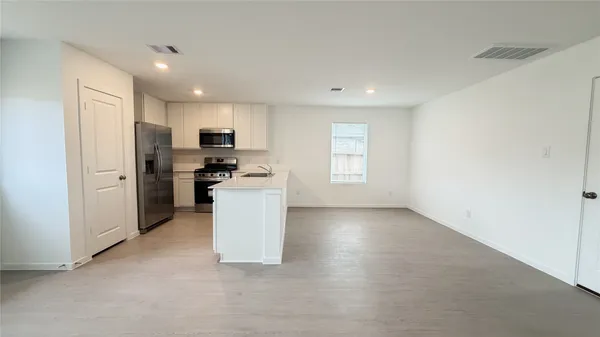 a kitchen with refrigerator and microwave