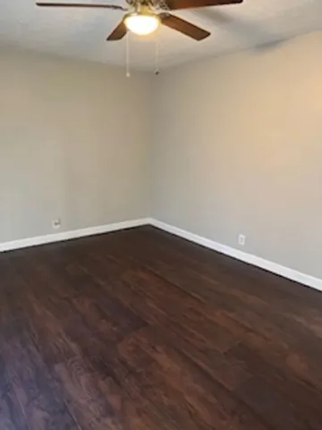 a view of a room with wooden floor