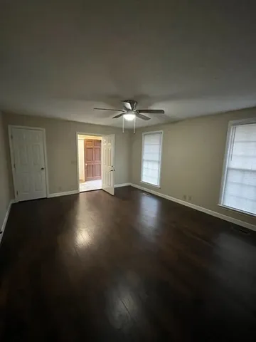 a view of wooden floor and windows in a room