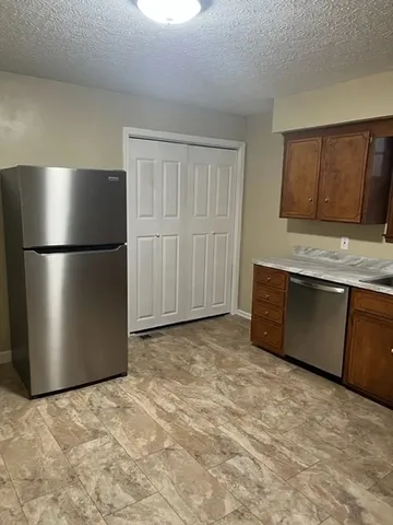 a kitchen with a refrigerator and cabinets