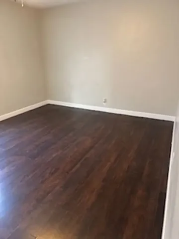 an empty room with wooden floor
