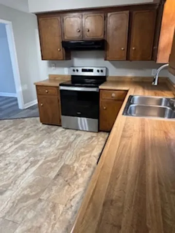 a kitchen with wooden cabinets and a sink