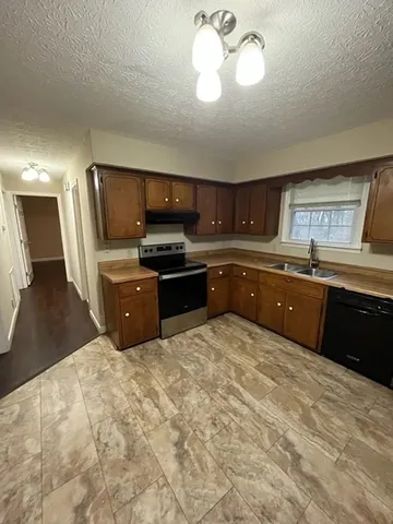 a large kitchen with cabinets and stainless steel appliances
