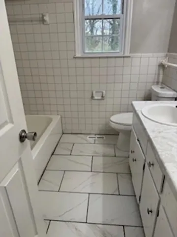a bathroom with a sink a toilet and window
