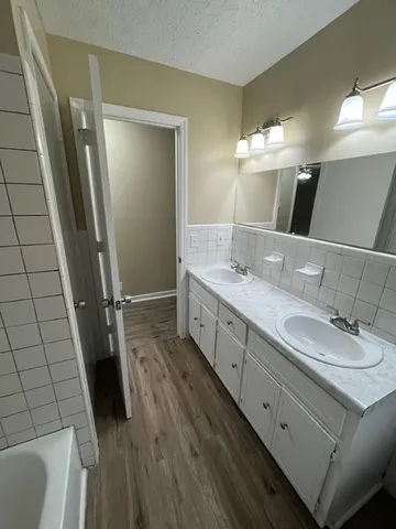 a bathroom with a double vanity sink and mirror