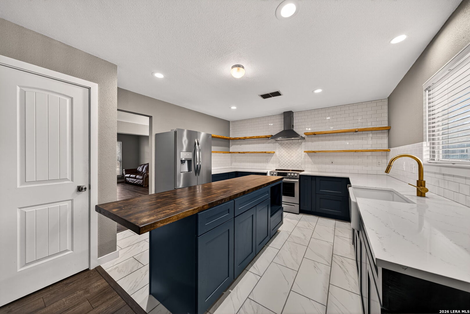 1016 Mourning Dove Schertz, TX 78154 - Photo 12 of 40 a kitchen with stainless steel appliances granite countertop a sink dishwasher and a refrigerator with wooden cabinets