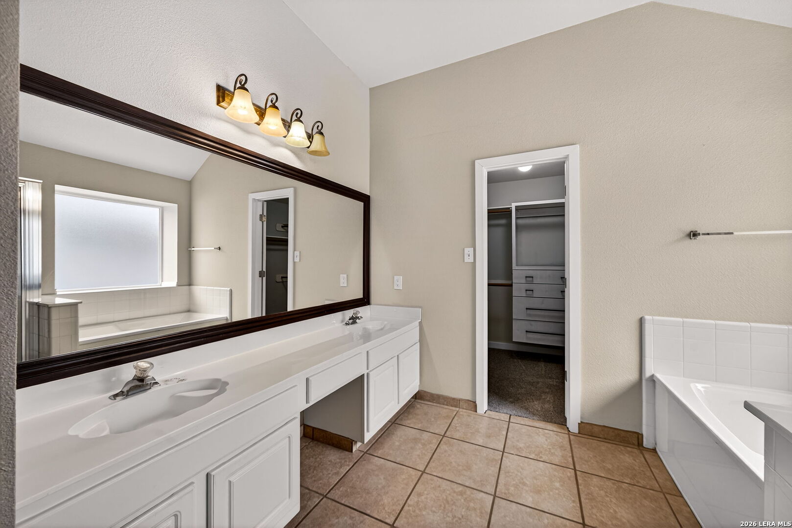 1016 Mourning Dove Schertz, TX 78154 - Photo 24 of 40 a bathroom with a sink a mirror and a bathtub