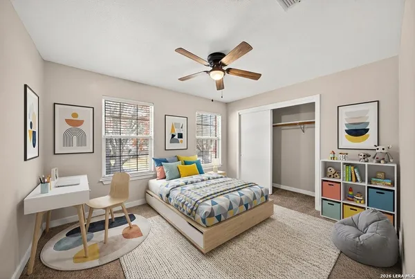 a bedroom with a bed a bookshelf and a chandelier