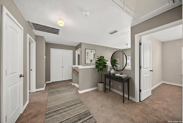 a view of a hallway to a room with entryway and a window