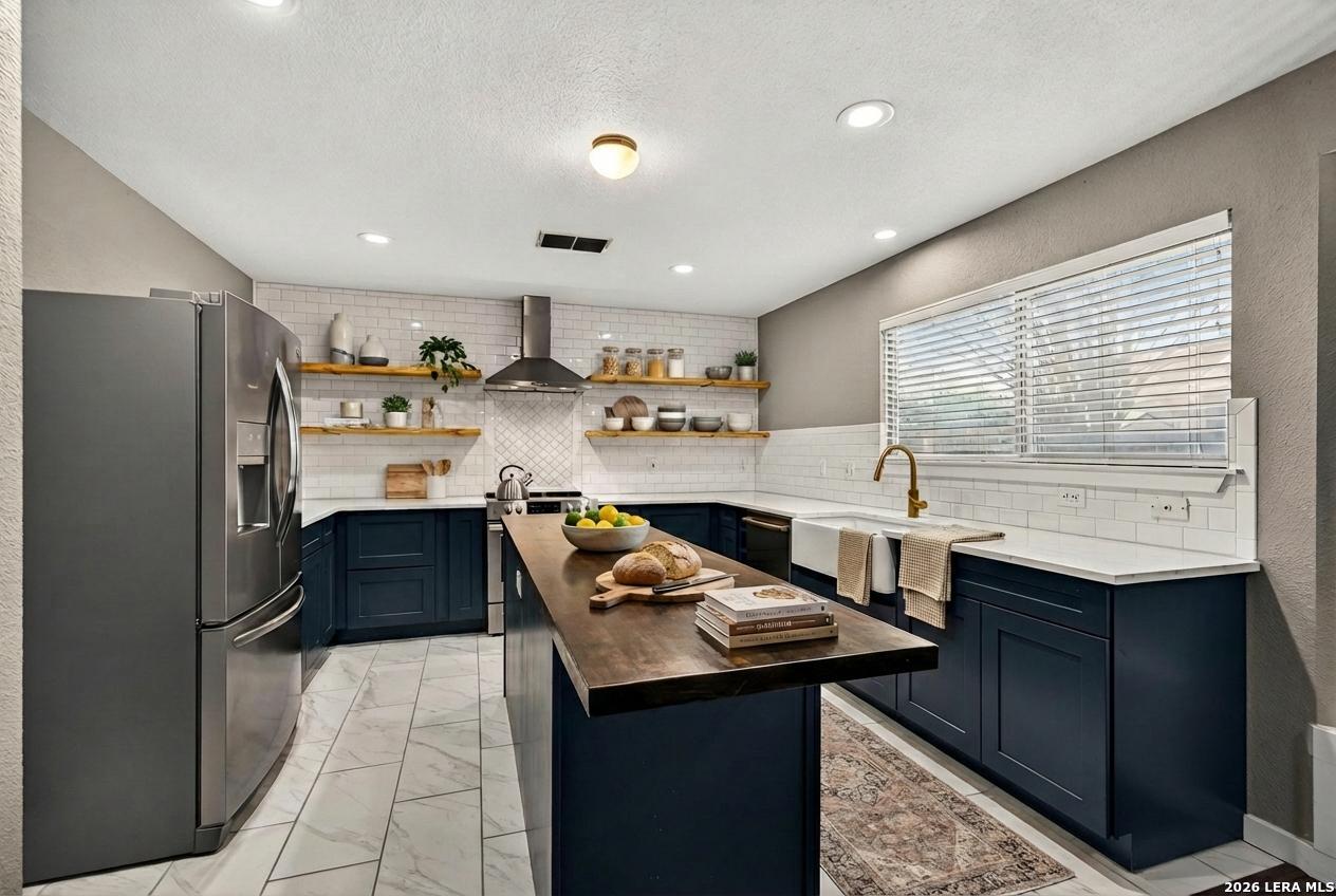 1016 Mourning Dove Schertz, TX 78154 - Photo 6 of 40 a kitchen with stainless steel appliances granite countertop a sink stove and refrigerator