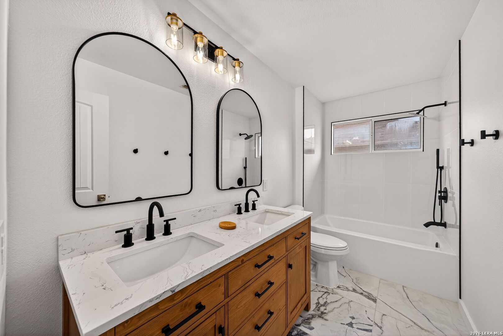 1016 Mourning Dove Schertz, TX 78154 - Photo 8 of 40 a bathroom with a double vanity sink mirror and shower