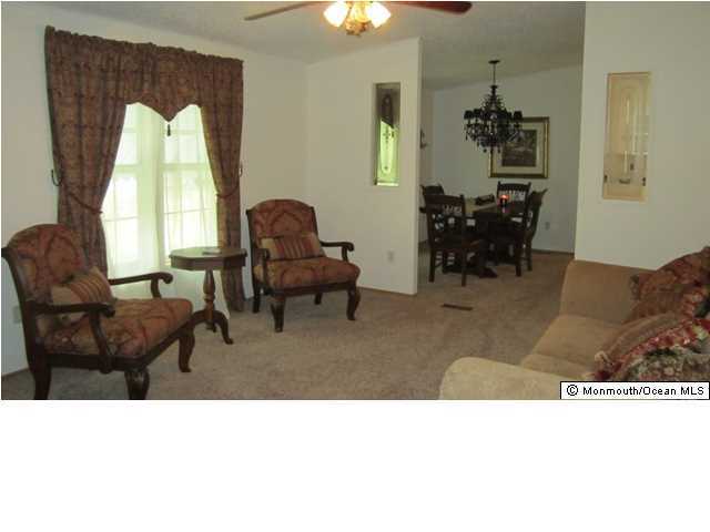 88 Village Road Morganville, NJ 07751 - Photo 3 of 10 a living room with furniture and a chandelier