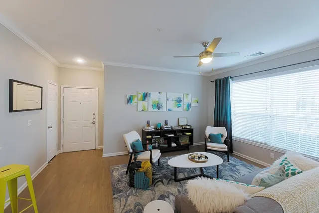 a living room with furniture and wooden floor