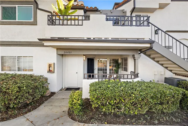 a front view of a house with a lots of plants
