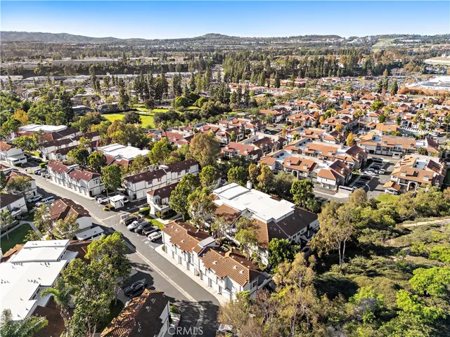 an aerial view of residential houses with city view