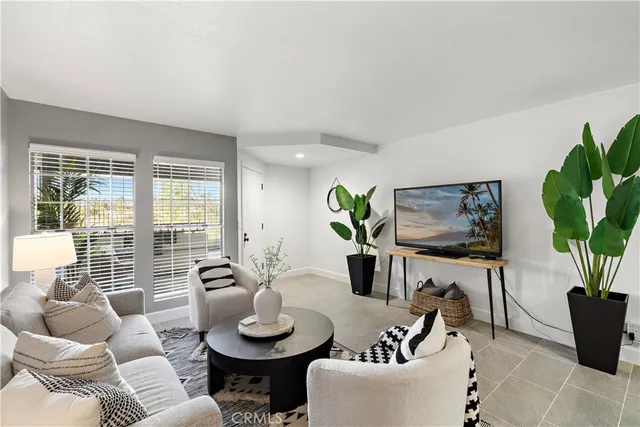 a living room with furniture and a potted plant