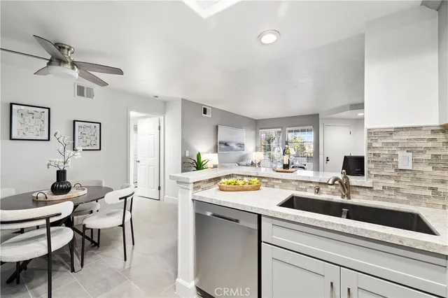 a kitchen with a sink cabinets and window
