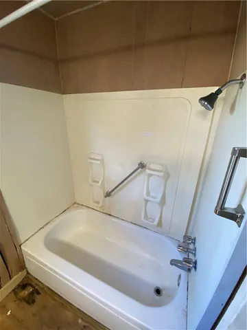 a bathroom with a white bathtub