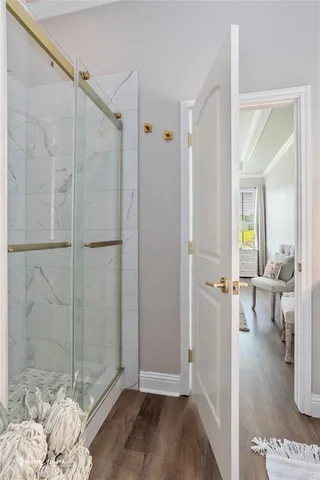 a view of a bathroom with a glass door shower