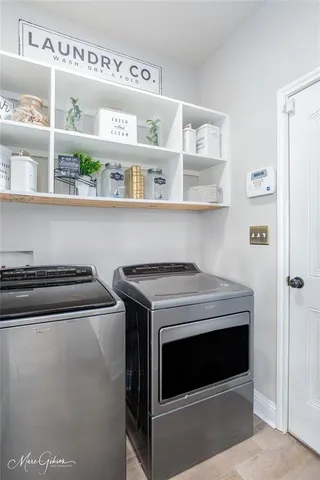 a view of kitchen cabinets with stainless steel appliances stove and refrigerator