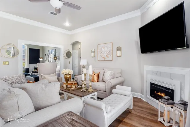 a living room with furniture a fireplace and a flat screen tv