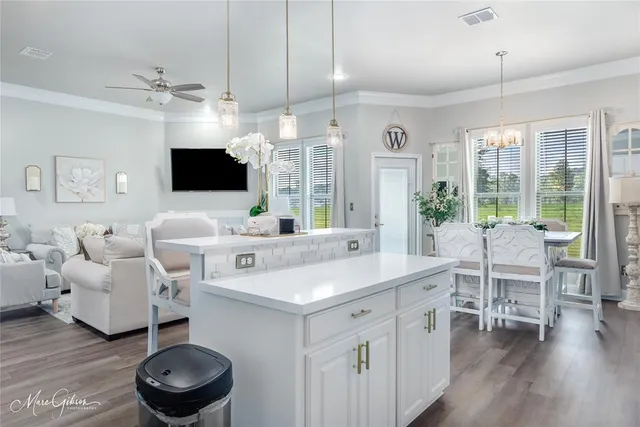 a living room with furniture a flat screen tv and a large window