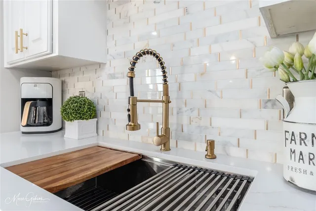 a room with painting on the wall and a wooden floor