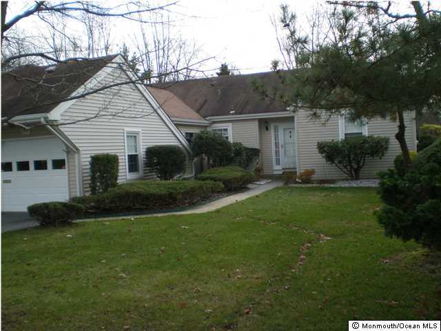 99 Evesham Road, Unit A Freehold, NJ 07728 - Photo 1 of 3 a view of a yard in front of a house