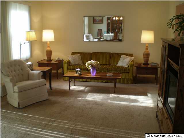 99 Evesham Road, Unit A Freehold, NJ 07728 - Photo 3 of 3 a living room with furniture and a flat screen tv