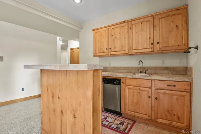 a kitchen with granite countertop cabinets stainless steel appliances and a counter space