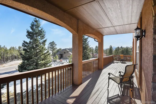 a view of a balcony with couch and wooden floor