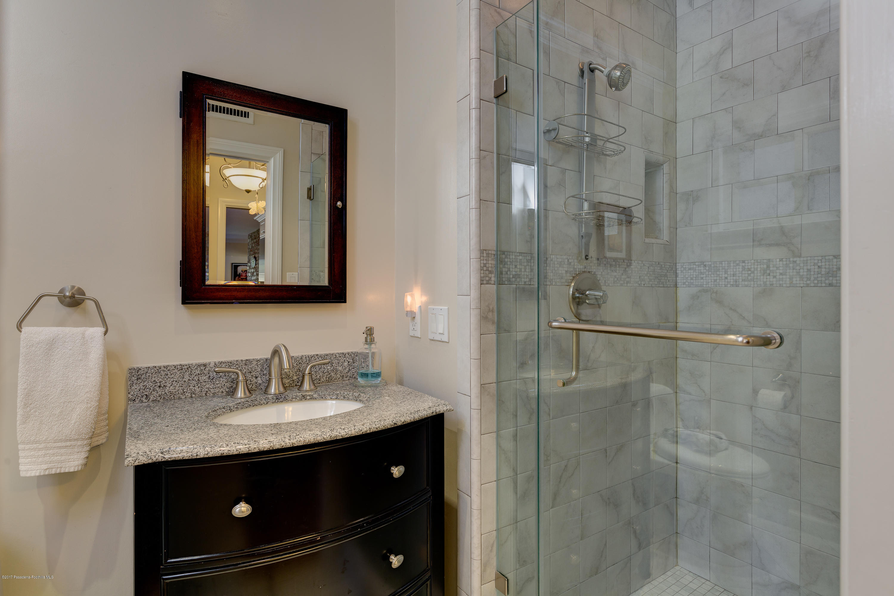 3740 Greenhill Road Pasadena, CA 91107 - Photo 11 of 23 a bathroom with a sink vanity granite shower and a mirror