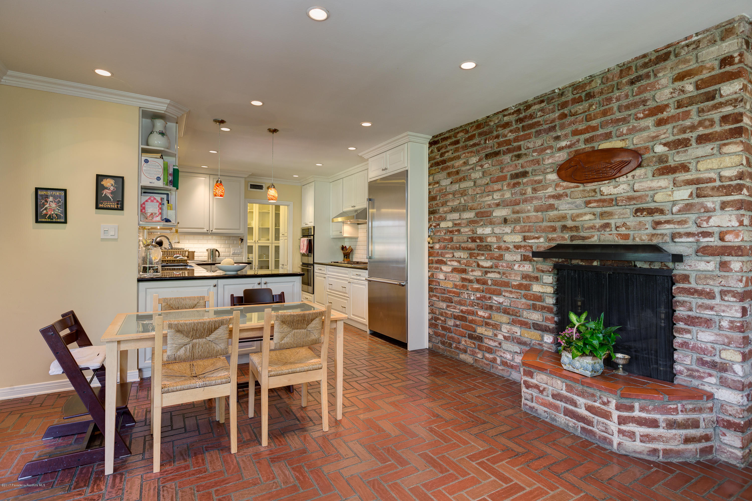 3740 Greenhill Road Pasadena, CA 91107 - Photo 8 of 23 a dining room with furniture and a fireplace