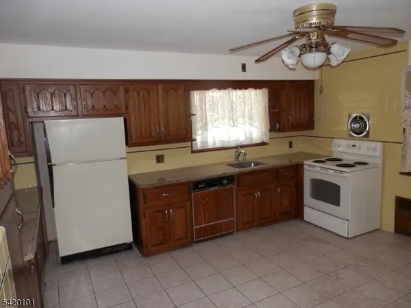 a kitchen with a white cabinets and white appliances