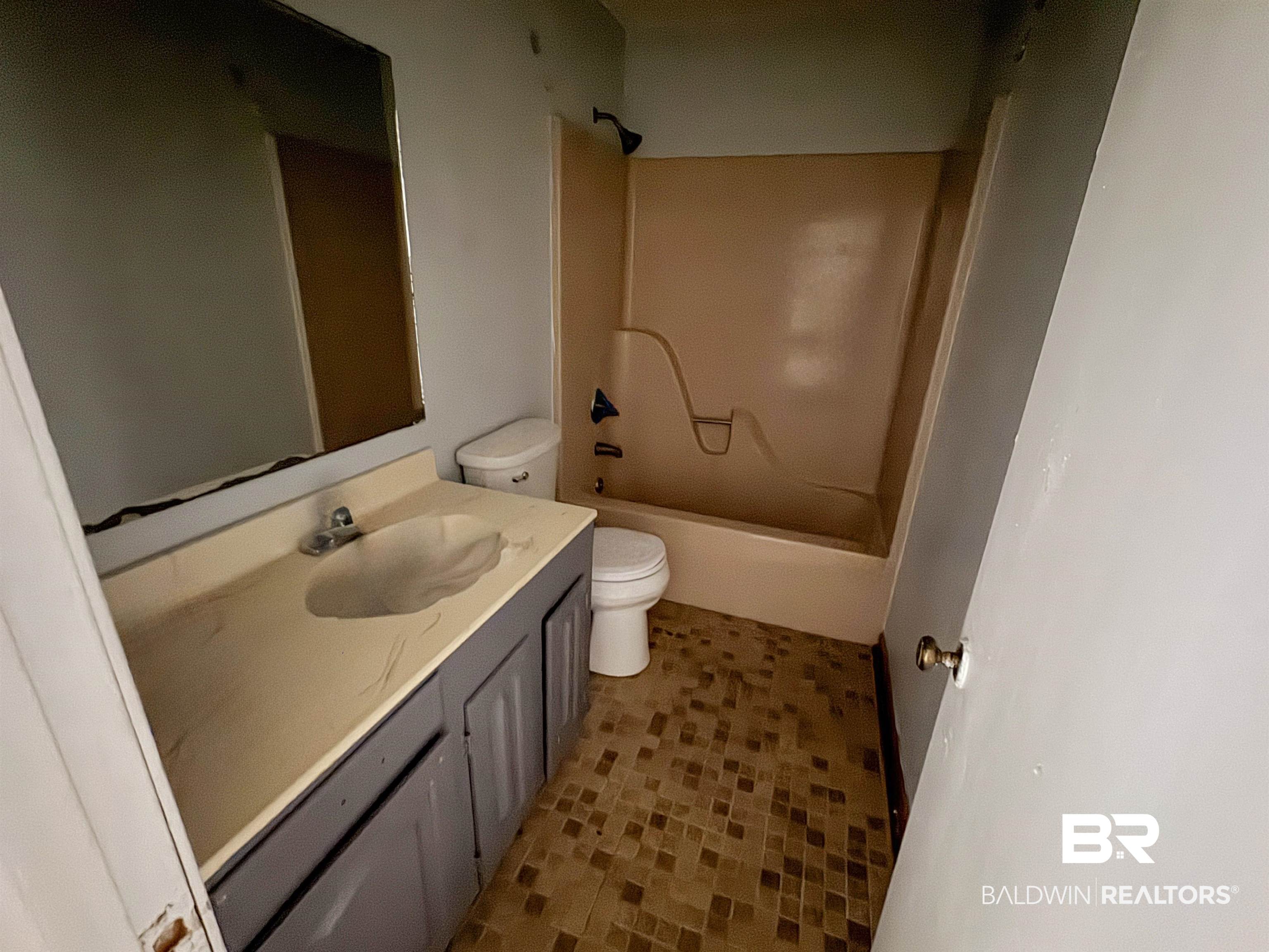 1227 Northgate Drive Atmore, AL 36502 - Photo 8 of 14 Bathroom featuring vanity and shower / tub combination