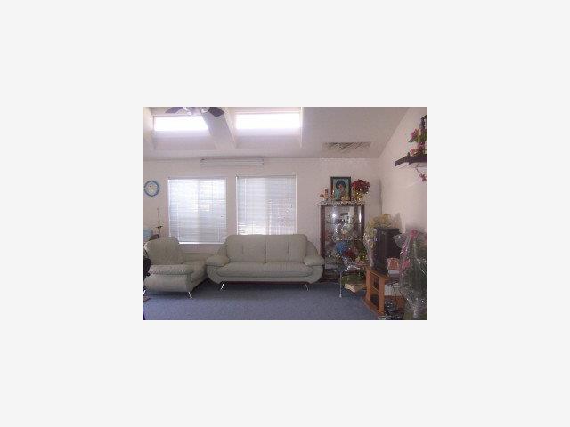 411 Lewis Road, Unit 276 San Jose, CA 95111 - Photo 4 of 9 a living room with a couch and a window