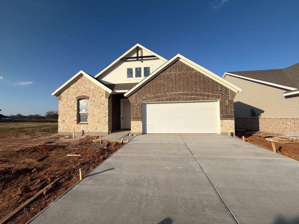 1249 Sabine River Lane Springtown, TX 76082 - Photo 1 of 9 a front view of a house with a yard and garage